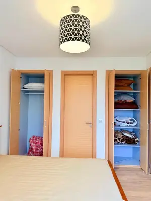 a bedroom with a bed and a closet at Prestigia Golf City Bouskoura in Bouskoura