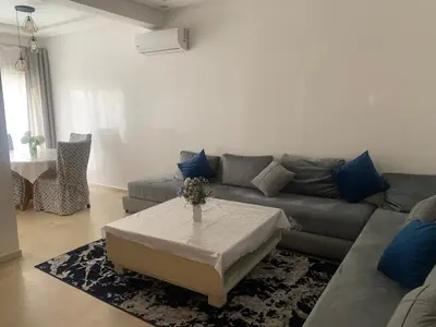 a living room with a couch and a table at Cozy apt in Bourgogne - Ain Diab Coast in Casablanca