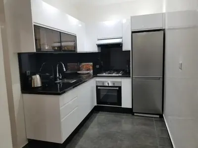 a kitchen with a sink and a refrigerator at Cozy apt in Bourgogne - Ain Diab Coast in Casablanca