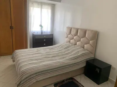 a bedroom with a large bed with a window at Cozy apt in Bourgogne - Ain Diab Coast in Casablanca