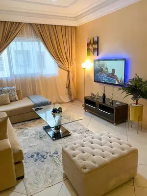 a living room with a couch and a tv at Appartement Clémentine C in Les Camps