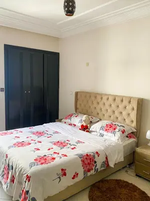 a bedroom with a bed with a teddy bear sitting on it at Appartement Clémentine C in Les Camps