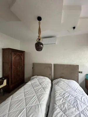 a bedroom with a bed and a ceiling at Chez Abir in Rabat