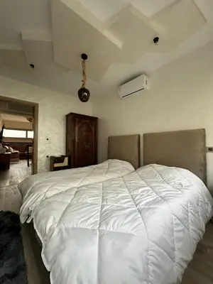 a bedroom with a large white bed in it at Chez Abir in Rabat