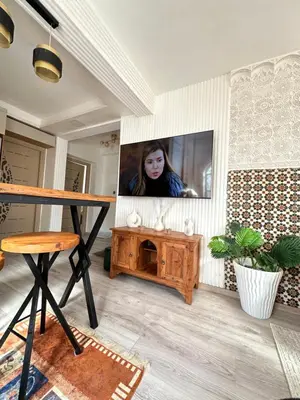a living room with a tv on the wall at Chez Abir in Rabat