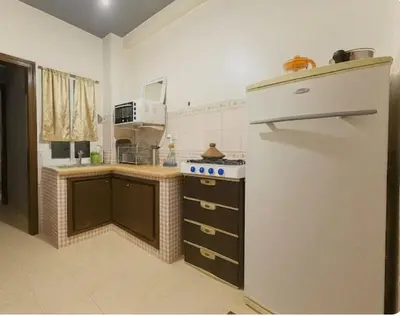 a kitchen with a refrigerator and a stove in it at Cosy appart 1min de casanearshore & Zinit in Casablanca