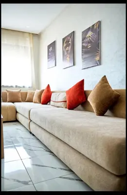 a long couch with pillows on it in a room at Magnifique studio disponible sur roche noire in Casablanca