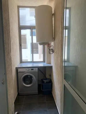 a laundry room with a washing machine and a window at Beach Ain Diab - Beautiful Apt in Bourgogne in Casablanca