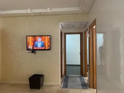 a television hanging on a wall in a room at Beach Ain Diab - Beautiful Apt in Bourgogne in Casablanca