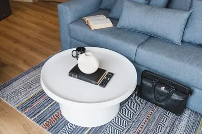a living room with a table with a book and a couch at Oasis Residence by GoodMove - Casablanca in Casablanca