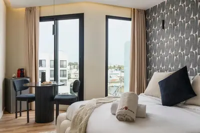 a hotel room with a bed and a table and chairs at Oasis Residence by GoodMove - Casablanca in Casablanca