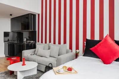 a living room with a red and white striped wall at Oasis Residence by GoodMove - Casablanca in Casablanca