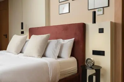 a bedroom with a large bed with white pillows at Oasis Residence by GoodMove - Casablanca in Casablanca