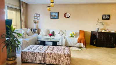 a living room with white couches and a coffee table at Elegant cultural 2-bedroom apartment in central Casablanca in Casablanca