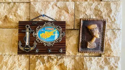 a sign on a wall with a picture and a sword at Elegant cultural 2-bedroom apartment in central Casablanca in Casablanca