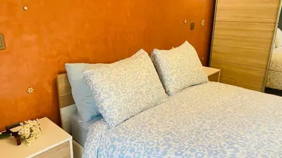 a bedroom with a bed with blue sheets and pillows at Elegant cultural 2-bedroom apartment in central Casablanca in Casablanca