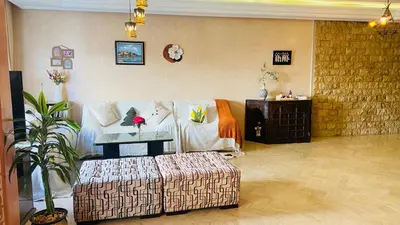 a living room with a couch and a table at Elegant cultural 2-bedroom apartment in central Casablanca in Casablanca