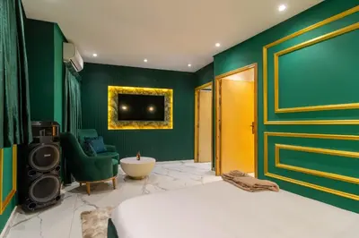 a bedroom with green walls and a bed and a tub at Casablanca Luxury Penthouse with Jacuzzi & Views in Casablanca
