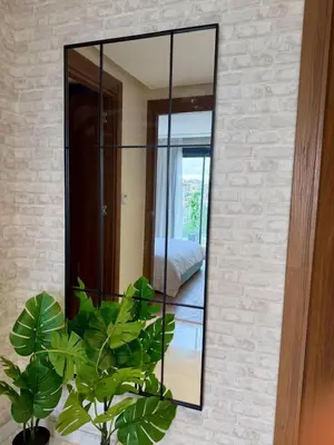 a mirror on a brick wall with plants in a room at New And Bright Terrace Panoramic View in Casablanca