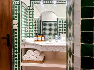 a bathroom with a sink and a mirror at Prestige appartement centre Agdal Rabat in Rabat