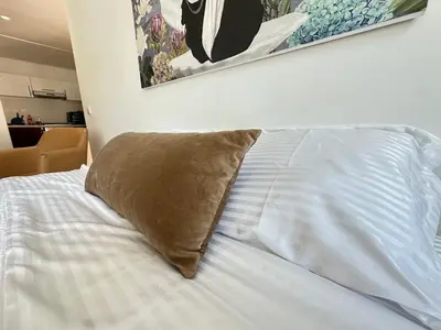 a white bed with a pillow on top of it at Chic central Stay in Agdal in Rabat