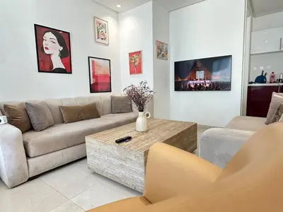 a living room with a couch and a coffee table at Chic central Stay in Agdal in Rabat