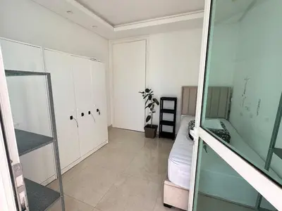 an empty room with a bed and a glass door at Chic central Stay in Agdal in Rabat