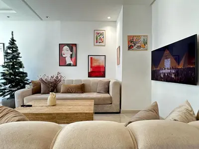 a living room with a couch and a christmas tree at Chic central Stay in Agdal in Rabat