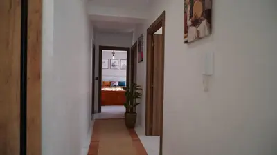 a hallway with a door and a potted plant at Bel appartement, piscine intérieure et extérieure in Temara