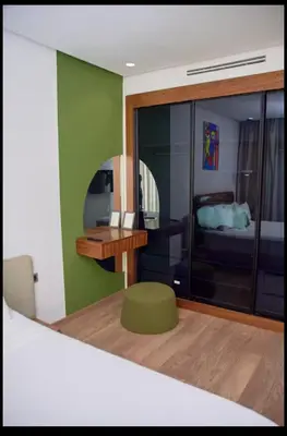 a room with a bedroom with a bed and a mirror at Cosy studio disponible sur maarif princesses in Casablanca