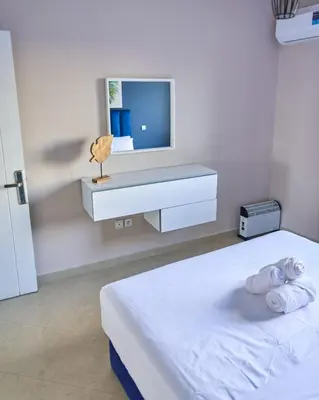 a white room with a bed and a tv at Joli studio disponible sur maarif boulevard danfa in Casablanca