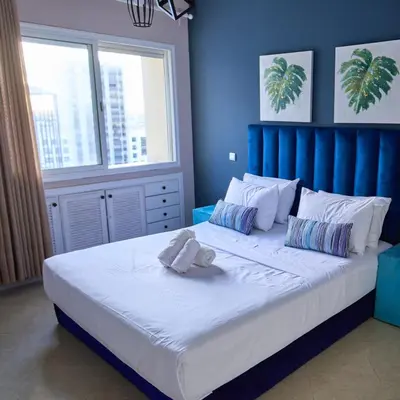a bedroom with a large bed with a blue headboard at Joli studio disponible sur maarif boulevard danfa in Casablanca