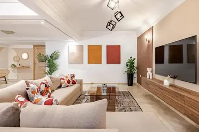 a living room with a couch and a tv at Moderne, 2 CH, Fibre optique, AC Garage Ascenseur in Rabat