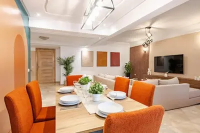 a dining room and living room with a table and chairs at Moderne, 2 CH, Fibre optique, AC Garage Ascenseur in Rabat