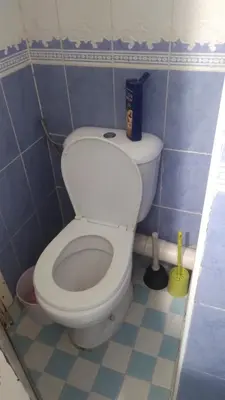 a bathroom with a white toilet in a blue room at Belle chambre sidi maarouf in Casablanca