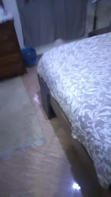 a bedroom with a bed and a rug on the floor at Belle chambre sidi maarouf in Casablanca