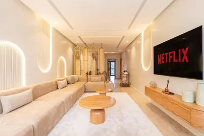 a living room with a couch and a tv at LuxArt Casablanca in Casablanca