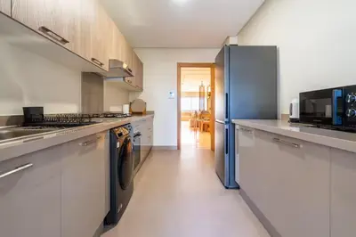 a kitchen with stainless steel appliances and white cabinets at LuxArt Casablanca in Casablanca