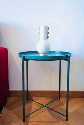 a blue table with a vase on top of it at Les princesses studio confortable in Maarif