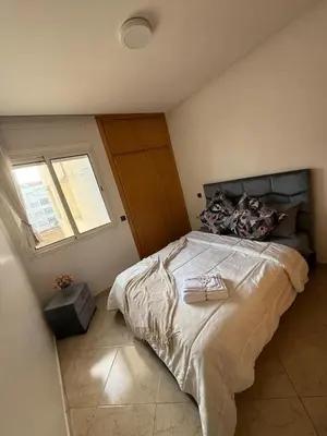 a bedroom with a large bed with a window at Charming 1 bedroom apartment Ocean living room, Rabat in Rabat