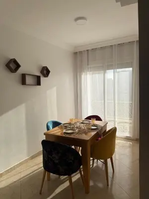 a dining room with a wooden table and chairs at Charming 1 bedroom apartment Ocean living room, Rabat in Rabat