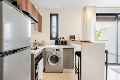 a kitchen with a washing machine and a washer at Centrale studio with Nice terasse in Maarif