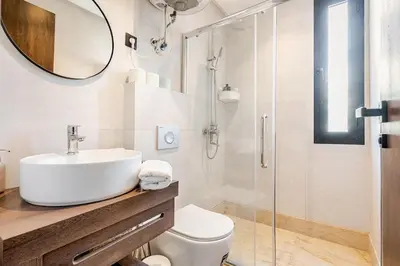 a bathroom with a sink and a toilet and a mirror at Centrale studio with Nice terasse in Maarif