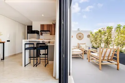 a kitchen and living room with a table and chairs at Centrale studio with Nice terasse in Maarif