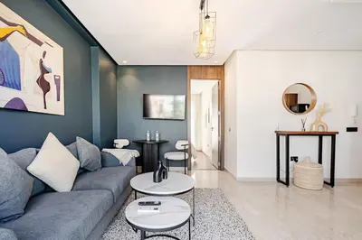 a living room with a couch and a table at Centrale studio with Nice terasse in Maarif