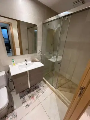 a bathroom with a shower and a sink and a toilet at Appartement convivial in Rabat