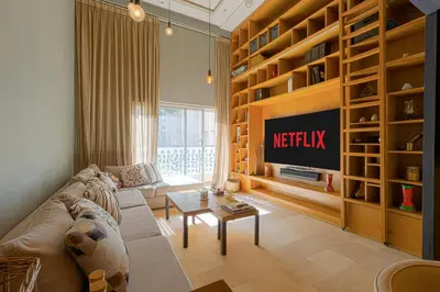 a living room with a couch and a tv at Luxury Duplex with Home Cinema Central Casablanca in Casablanca