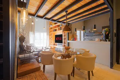 a kitchen and dining room with a glass table and chairs at Luxury Duplex with Home Cinema Central Casablanca in Casablanca