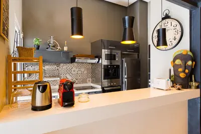 a kitchen with a counter with a stove top oven at Luxury Duplex with Home Cinema Central Casablanca in Casablanca