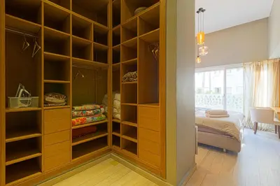 a closet with wooden shelves in a bedroom at Luxury Duplex with Home Cinema Central Casablanca in Casablanca
